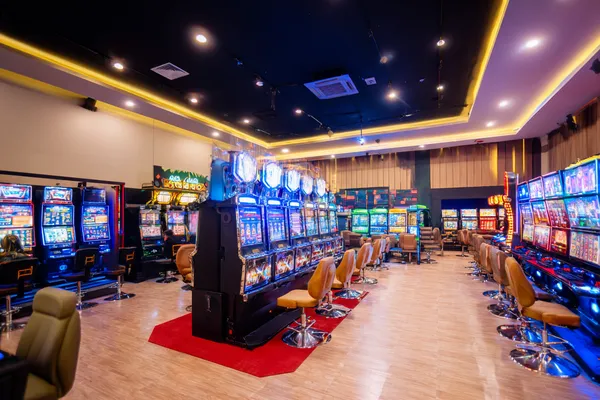 A glamorous woman holding casino chips in a neon-lit environment, representing the premium online casino atmosphere of MALI WIN.